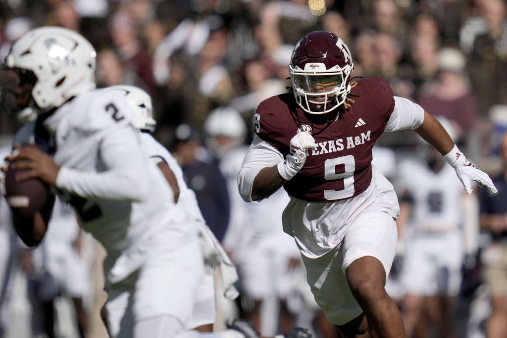 FILE - Texas A&M defensive end Cashius Howell (9) rushes Samford quarterback Quincy Crittendon (2) during the first quarter of an NCAA college football game Saturday, Nov. 22, 2025, in College Station, Texas. (AP Photo/Sam Craft, File)
