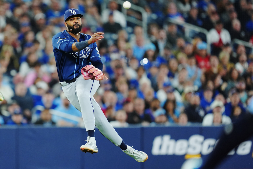 Tampa Bay Rays third baseman Junior Caminero (13) throws to first base during the sixth inning of a baseball game against the Toronto Blue Jays in Toronto on Tuesday, May 12, 2026. (Frank Gunn/The Canadian Press via AP)
