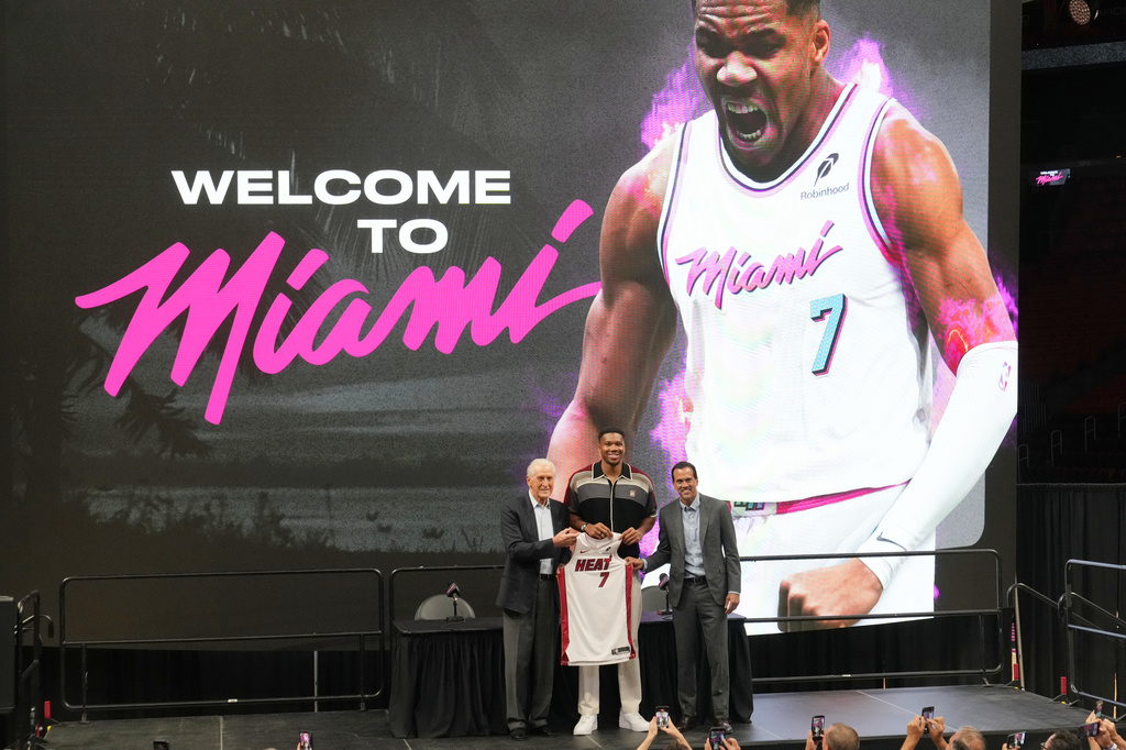 Miami Heat President Pat Riley, left, head coach Erik Spoelstra, right, stand with Giannis Antetokounmpo as he is introduced to the team Thursday, July 16, 2026, in Miami. (AP Photo/Marta Lavandier)