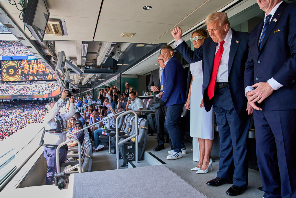 FILE - President Donald Trump, from right, pumps his fist as he and first lady Melania Trump look to the crowd while attending the Club World Cup final soccer match, at MetLife Stadium in East Rutherford, N.J., July 13, 2025. (AP Photo/Jacquelyn Martin, File)