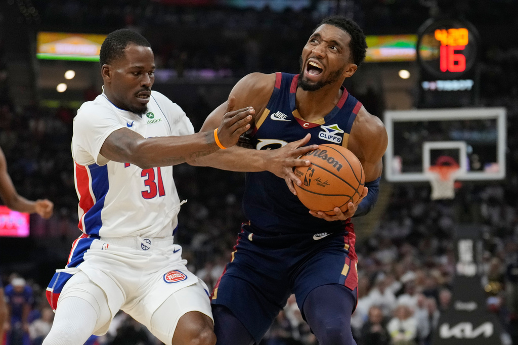 Cleveland Cavaliers' Donovan Mitchell, right, is fouled by Detroit Pistons' Javonte Green (31) in the first half of Game 4 of a second-round NBA basketball playoff series Monday, May 11, 2026, in Cleveland. (AP Photo/Sue Ogrocki)