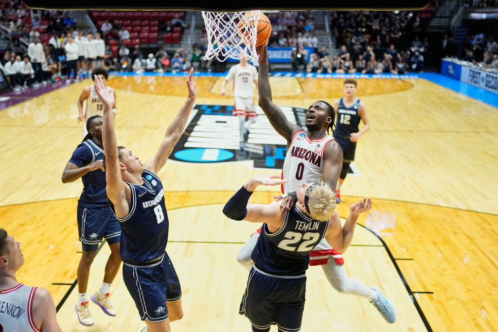 Arizona guard Jaden Bradley (0) shoots over Utah State forward Karson Templin (22) during the second half of a game in the second round of the NCAA college basketball tournament Sunday, March 22, 2026, in San Diego. (AP Photo/Mark J. Terrill)