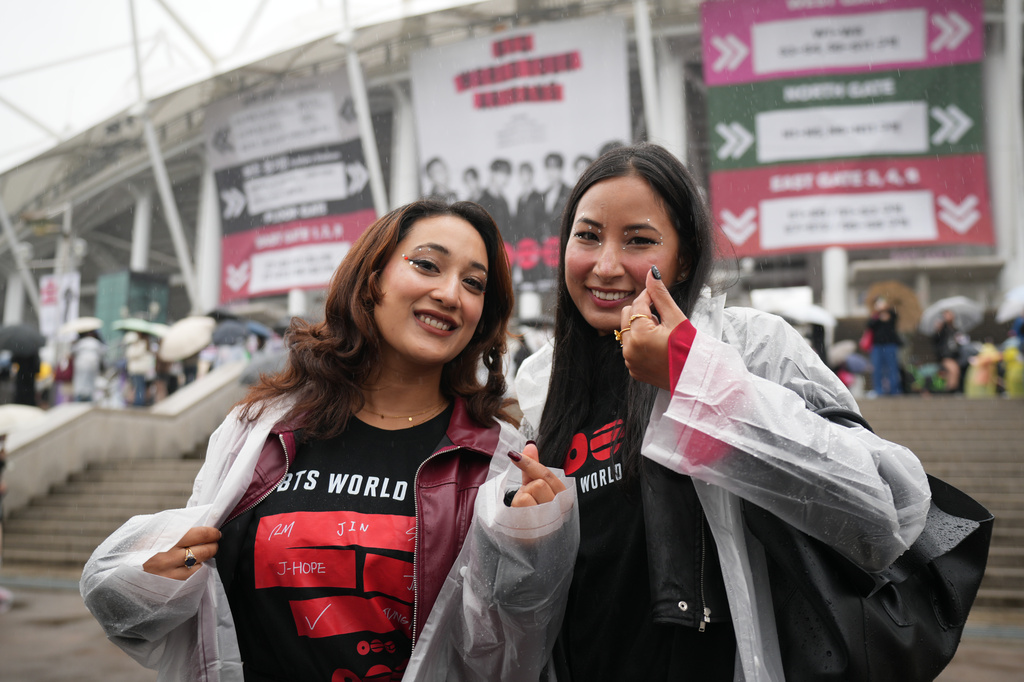 Fans of K-pop band BTS pose for a photo outside the venue for the BTS World Tour Arirang in Goyang, South Korea, Thursday, April 9, 2026. (AP Photo/Lee Jin-man)
