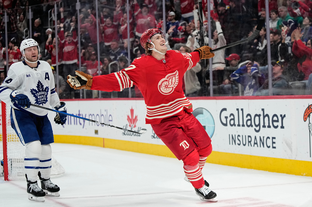 FILE - Detroit Red Wings defenseman Simon Edvinsson, right, celebrates near Toronto Maple Leafs defenseman Morgan Rielly, left, after scoring the winning goal during overtime of an NHL hockey game, Dec. 28, 2025, in Detroit. (AP Photo/Ryan Sun, File)