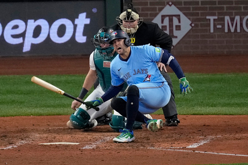 Toronto Blue Jays' George Springer falls after being hit by a pitch against the Seattle Mariners during the seventh inning in Game 5 of baseball's American League Championship Series, Friday, Oct. 17, 2025, in Seattle. (AP Photo/David J. Phillip) Toronto Blue Jays' George Springer falls after being hit by a pitch against the Seattle Mariners during the seventh inning in Game 5 of baseball's American League Championship Series, Friday, Oct. 17, 2025, in Seattle. (AP Photo/David J. Phillip)