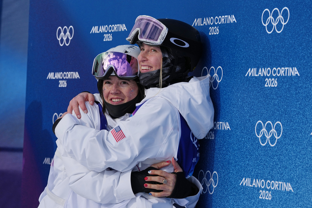 United States' Jaelin Kauf, left, hugs United States' Elizabeth Lemley during the women's freestyle skiing moguls finals at the 2026 Winter Olympics, in Livigno, Italy, Wednesday, Feb. 11, 2026. (AP Photo/Gregory Bull)