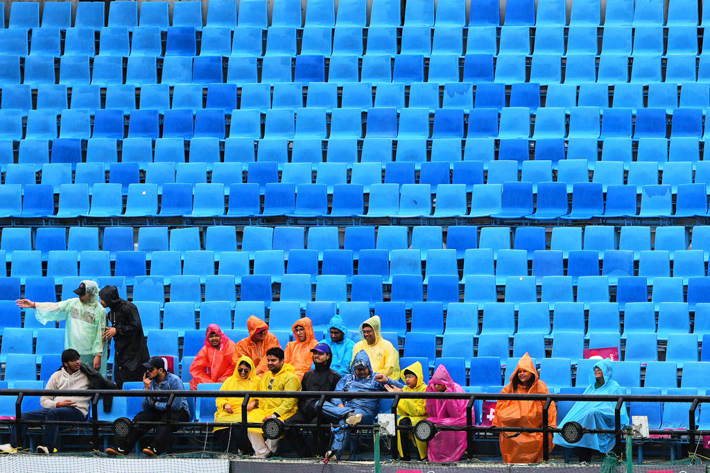 Indian supporter sit in the stands as rain delayed the start of play on the first ODI cricket match between Afghanistan and India in Dharamshala, India, Saturday, June 13, 2026. (AP Photo/Ashwini Bhatia)