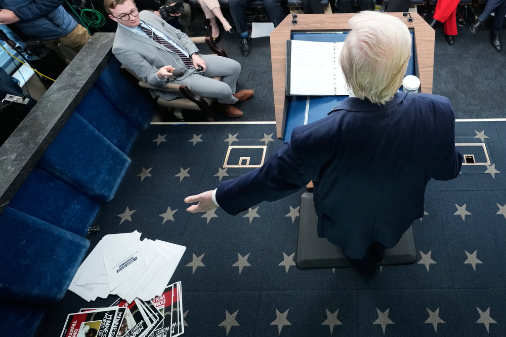Documents are seen on the ground after President Donald Trump displayed them during a press briefing at the White House in Washington, Tuesday, Jan. 20, 2026. (AP Photo/Mark Schiefelbein)