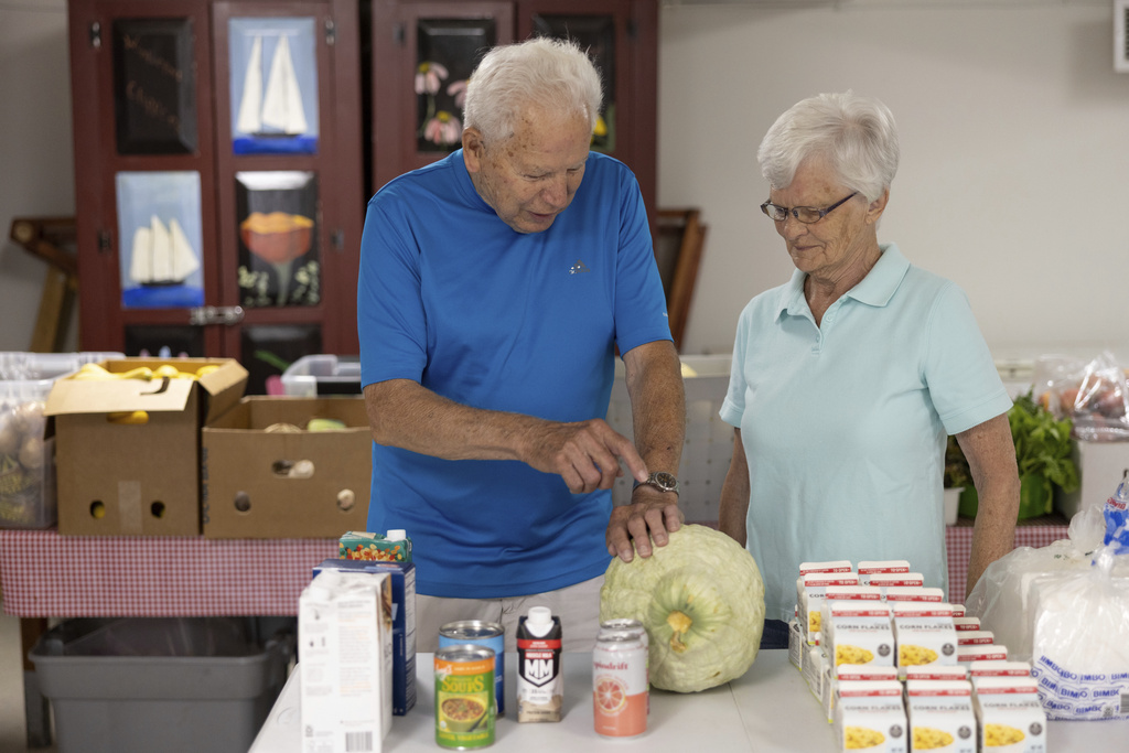Keith Ritchie, 89, and Betty Williams, 88, the Neighbor's Cupboard pantry's two eldest volunteers, in Winterport, Maine, on Wednesday, Sept. 3, 2025. (Katherine Emery/The Maine Monitor via AP)