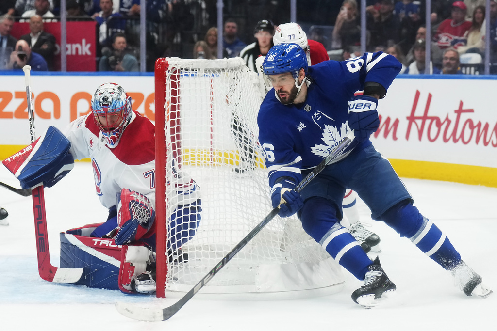 Toronto Maple Leafs' Kirill Marchenko (86) tries a wraparound on Montreal Canadiens goaltender Jakub Dobes (75) during the second period of an NHL hockey game against the Montreal Canadiens in Toronto, Tuesday, Sept. 29, 2026. (Nathan Denette/The Canadian Press via AP)