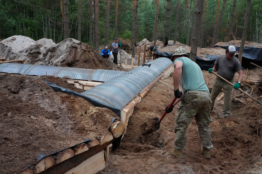 Ukrainian workers build a strongpoint close to the Ukraine-Belarus border in an undisclosed location in Ukraine Tuesday, July 7, 2026. (AP Photo/Efrem Lukatsky)