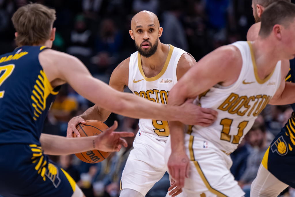 Boston Celtics guard Derrick White (9) looks to pass the ball during the second half of an NBA basketball game against the Indiana Pacers in Indianapolis, Monday, Jan. 12, 2026. (AP Photo/Doug McSchooler)