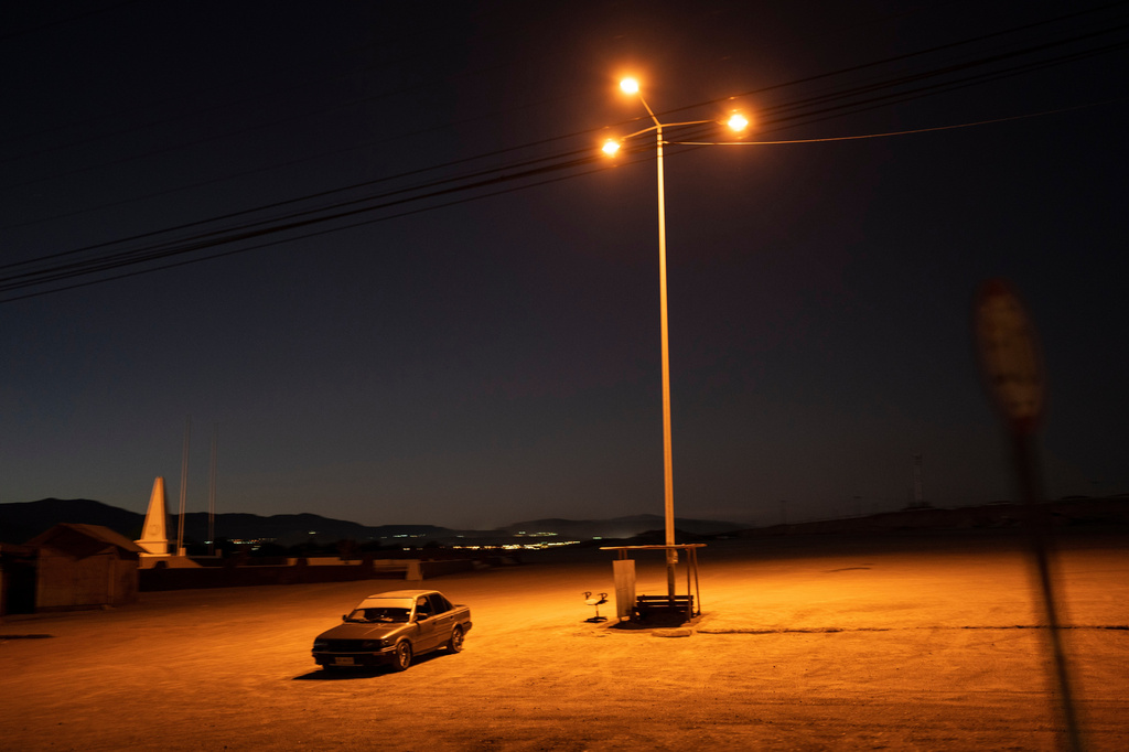FILE - A driver sits in his car in an empty parking lot in Calama, Chile, Friday, April 14, 2023. (AP Photo/Rodrigo Abd, File)