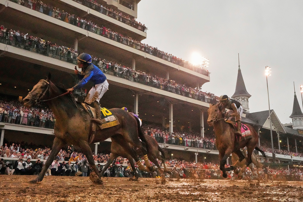 FILE - Sovereignty, ridden by Junior Alvarado, left, crosses the finish line to win the 151st running of the Kentucky Derby horse race followed by Journalism, ridden by Umberto Rispoli, May 3, 2025, at Churchill Downs in Louisville, Ky. (AP Photo/Abbie Parr, File)