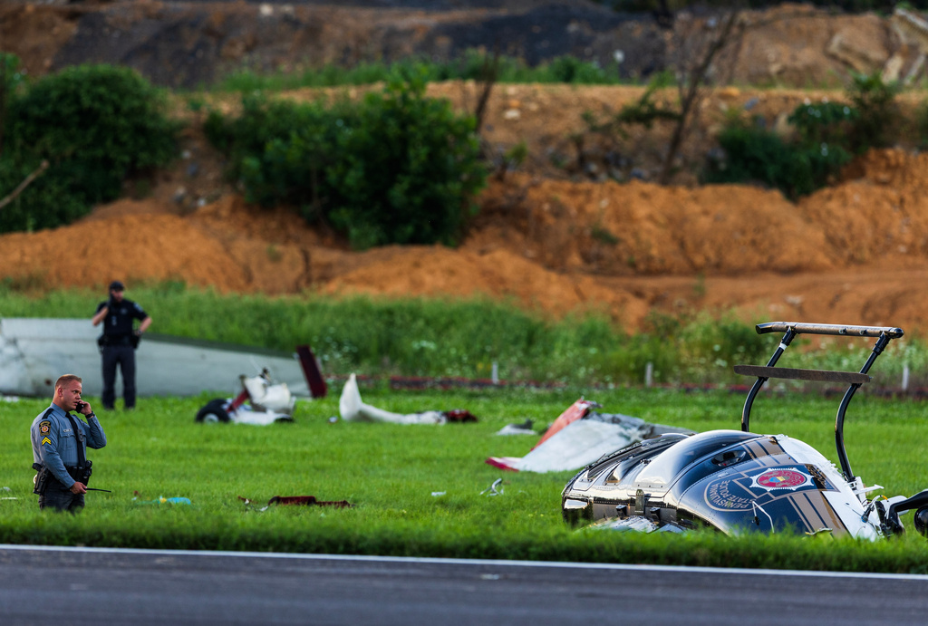 Authorities investigate a crash between a Pennsylvania State Police helicopter and a small plane at the Carlisle airport in Carlisle, Pa. Wednesday, Aug. 19, 2026. (Sean Simmers/The Patriot-News via AP)