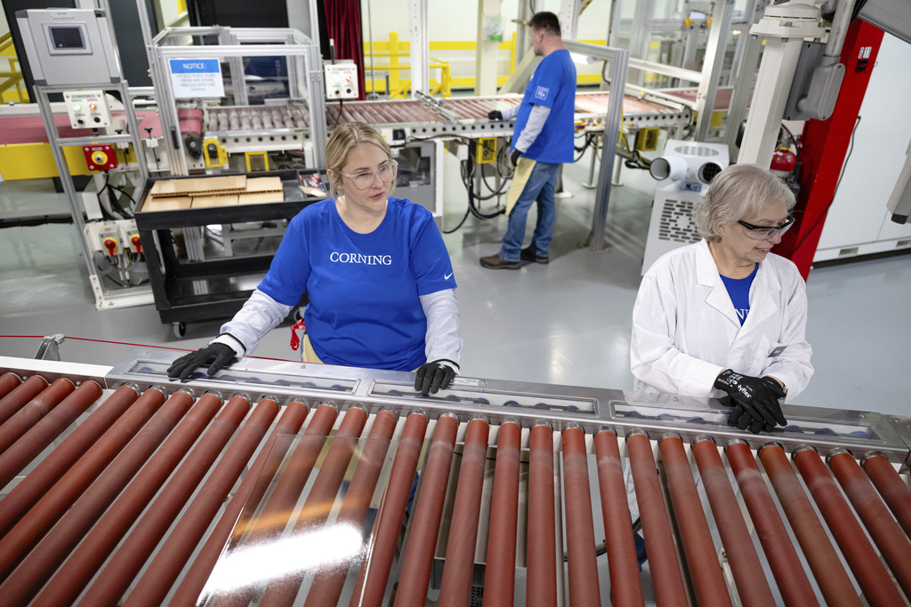 Quality control employees watch as lengths of glass move down the line during a tour of Corning's iPhone glass manufacturing facility Friday, Sept. 12, 2025, in Harrodsburg, Ky. (AP Photo/Jon Cherry)