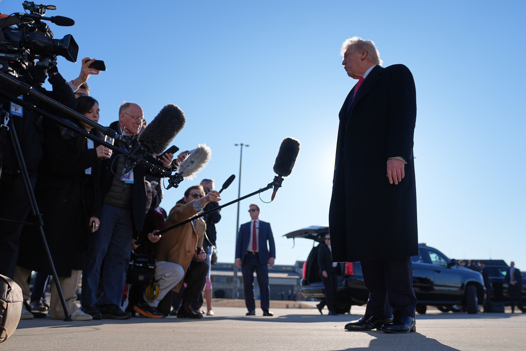 President Donald Trump speaks to reporters before boarding Air Force One at Pope Army Airfield, in Fort Bragg, N.C., Friday, Feb. 13, 2026, en route to Palm Beach, Fla. (AP Photo/Matt Rourke)