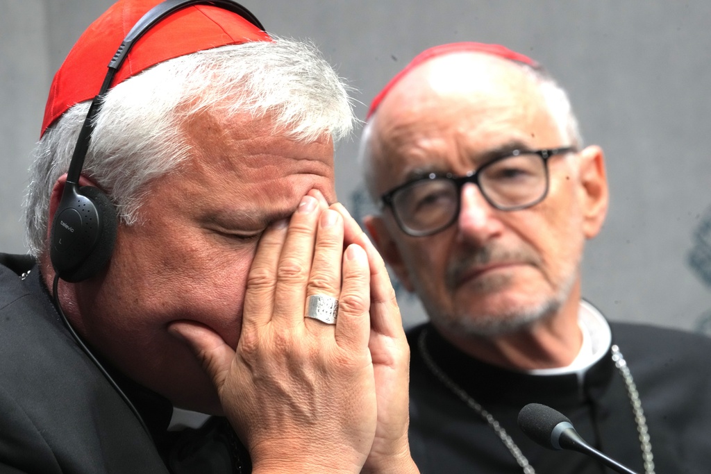 Cardinals Konrad Krajewski, left, and Michael Czerny attend a press conference at the Vatican to present Pope Leo XIV's exhortation "Dilexi te"about love for the poor, Thursday, Oct. 9, 2025. (AP Photo/Domenico Stinellis)