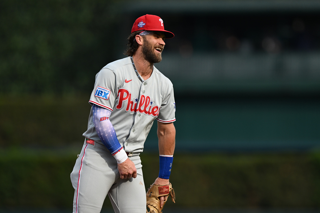 Philadelphia Phillies' Bryce Harper laughs with the first base umpire after tagging out Detroit Tigers' Matt Vierling on a pickoff play in the first inning of a baseball game, Saturday, July 11, 2026, in Detroit. (AP Photo/Lon Horwedel)
