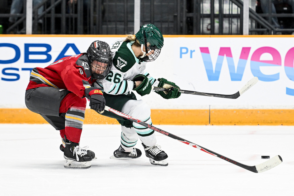 Ottawa Charge's Jocelyne Larocque (3) chases down Boston Fleet's Ella Huber (26) during the second period of an PWHL hockey game in Ottawa, Saturday, Feb. 28, 2026. (Spencer Colby/The Canadian Press via AP)