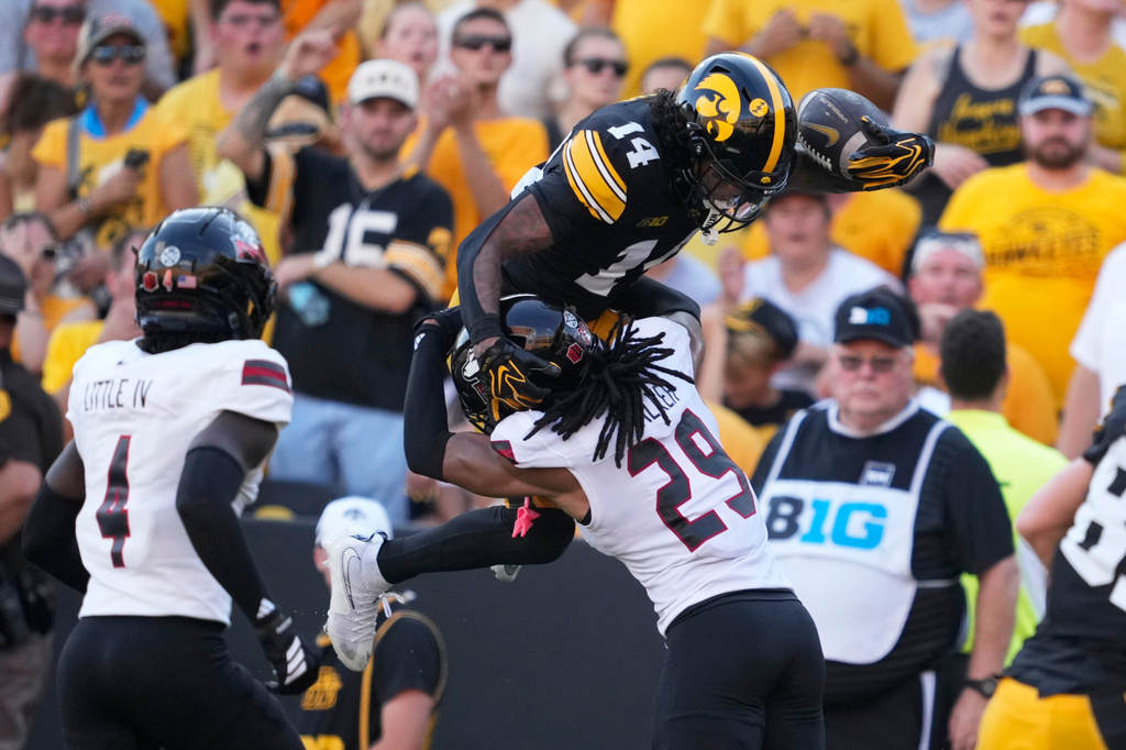 Iowa wide receiver Tony Diaz (14) is tackled by Northern Illinois cornerback Romelo Walker (29) after catching a pass during the first half of an NCAA college football game, Saturday, Sept. 5, 2026, in Iowa City, Iowa. (AP Photo/Charlie Neibergall)