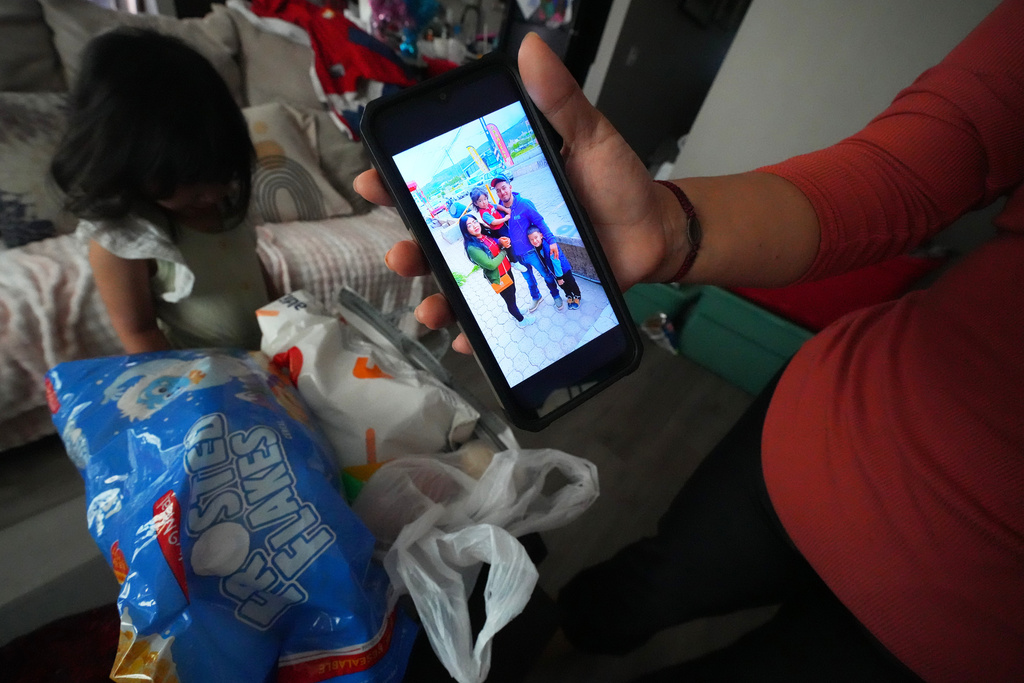 Cristina Osornio shows a photo, Nov. 18, 2025, in Rogers, Ark., from a recent trip to San Luis Potosi, Mexico, where she took her two daughter to see her husband, Edwin Sanchez-Mendoza, who signed deportation papers after being held in an immigration detention center for several months. (AP Photo/Julio Cortez)