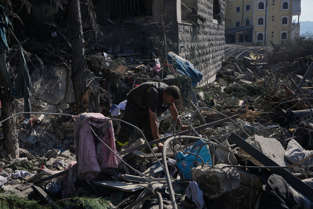 A rescue worker searches for victims under the rubble of a building destroyed in an Israeli airstrike in the southern village of Kfar Rumman, Lebanon, Monday, Sept. 7, 2026. (AP Photo/Mohammed Zaatari)