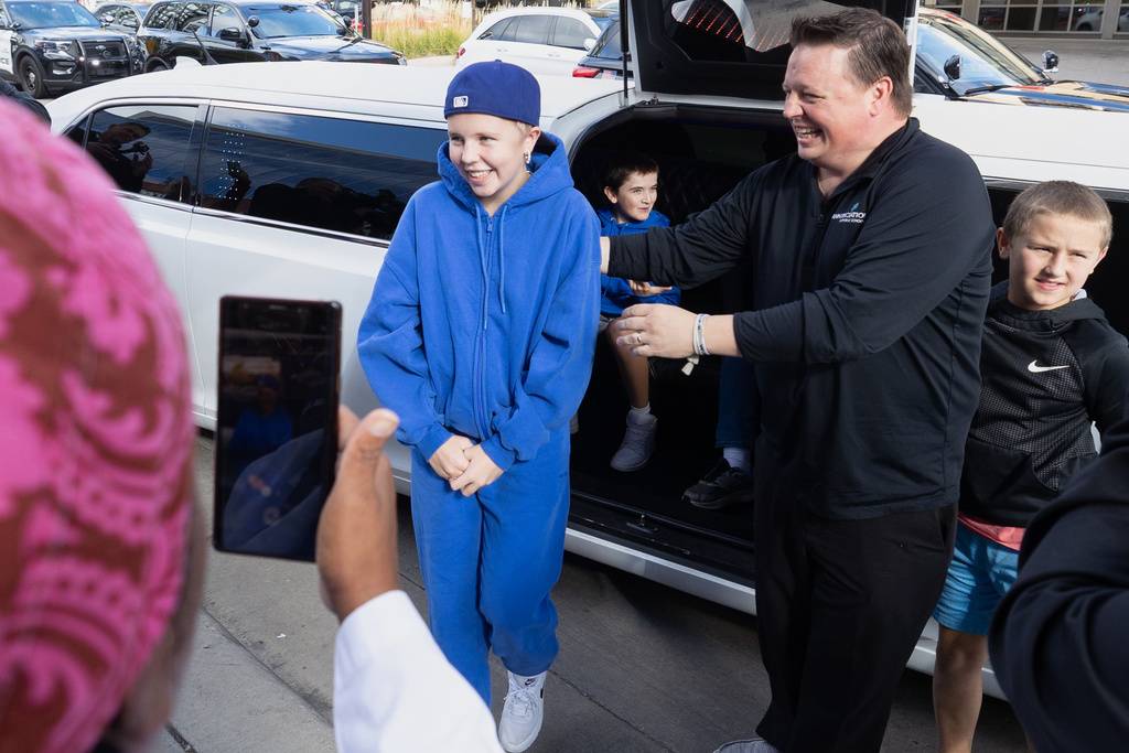 In this photo provided by the Catholic Spirit/Archdiocese of Saint Paul and Minneapolis, Sophia Forchas, an Annunciation Church and School mass shooting victim, and her father, Tom Forchas, right, arrive at the Hennepin County Medical Center on Thursday, Oct. 23, 2025, in Minneapolis. (The Catholic Spirit/Archdiocese of Saint Paul and Minneapolis via AP)