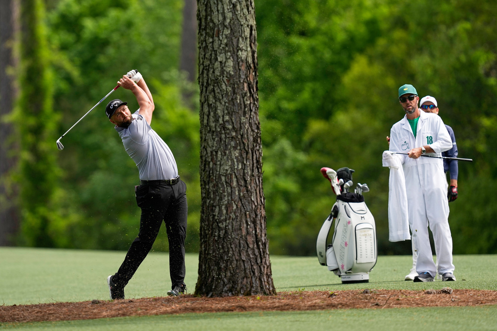 Jon Rahm, of Spain, hits from the fairway on the 11th hole during a practice round ahead of the Masters golf tournament at the Augusta National Golf Club, Tuesday, April 7, 2026, in Augusta, Ga. (AP Photo/David J. Phillip)