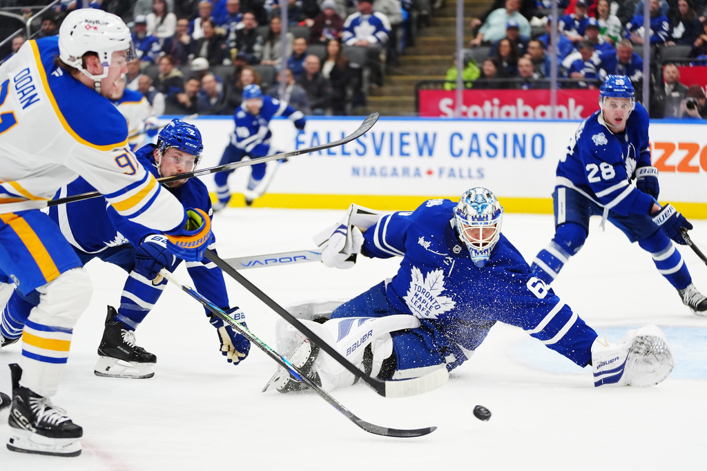 Toronto Maple Leafs goaltender Joseph Woll (60) stops Buffalo Sabres' Josh Doan (91) during third period NHL action in Toronto on Tuesday, Jan. 27, 2026. (Frank Gunn/The Canadian Press via AP)