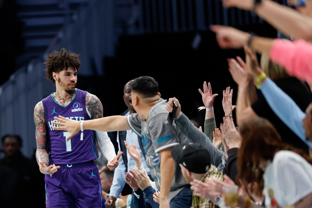 Charlotte Hornets guard LaMelo Ball (1) celebrates with fans after hitting a three-pointer during the first half of an NBA basketball game against the Indiana Pacers in Charlotte, N.C., Thursday, Jan. 8, 2026. (AP Photo/Nell Redmond)
