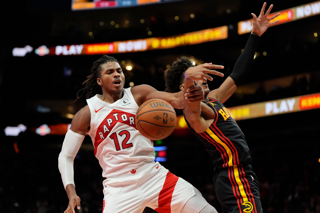 Toronto Raptors forward Collin Murray-Boyles (12) collides with Atlanta Hawks forward Jalen Johnson (1) during the first half of an NBA basketball game, Friday, Nov. 7, 2025, in Atlanta. (AP Photo/Mike Stewart)
