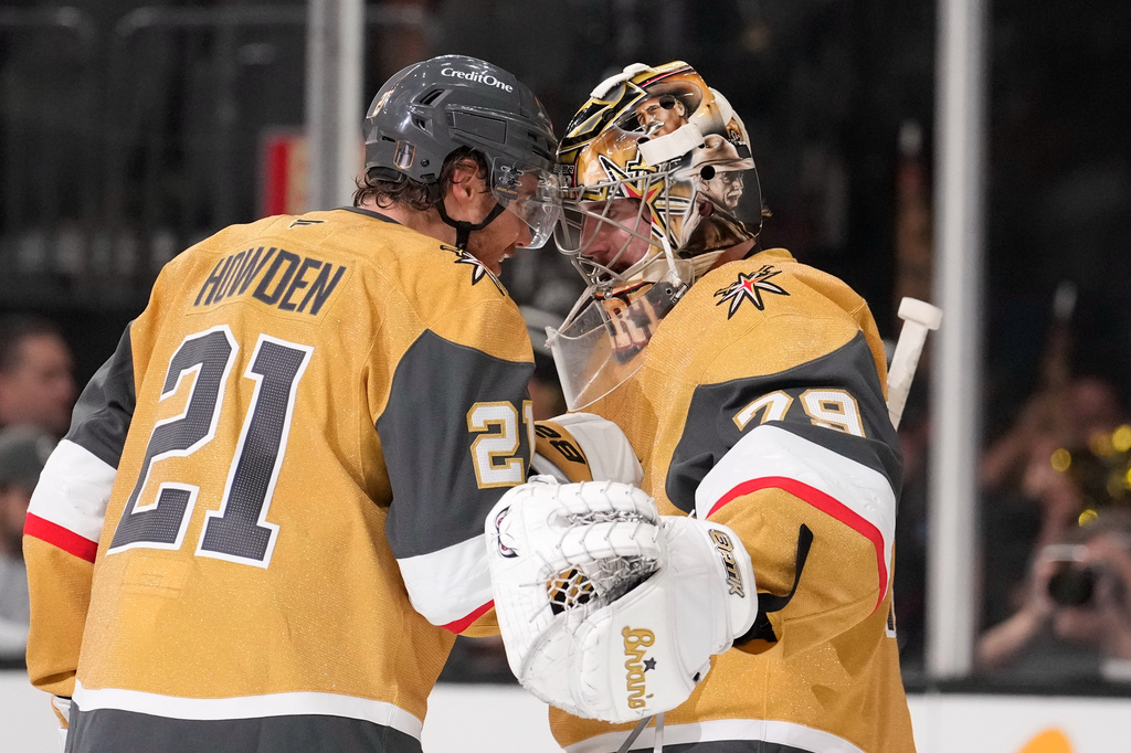 Vegas Golden Knights center Brett Howden, left, and goaltender Carter Hart congratulate each other after the Golden Knights defeated the against the Colorado Avalanche in Game 3 of the Western Conference finals NHL hockey Stanley Cup playoff series Sunday, May 24, 2026, in Las Vegas. (AP Photo/Mark J. Terrill)
