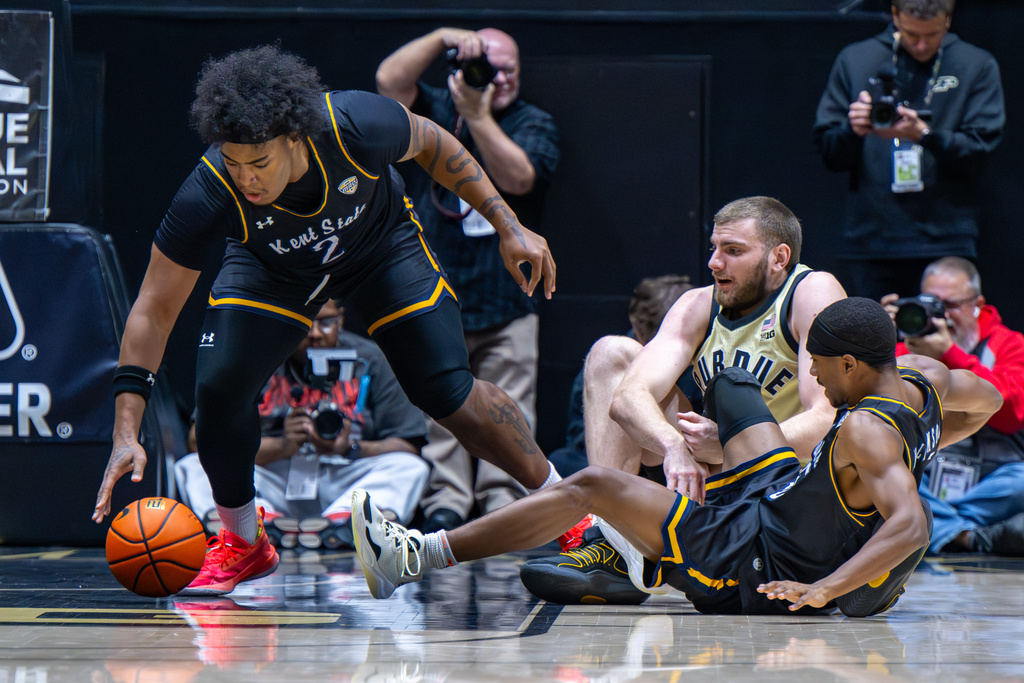 Kent State forward Rob Whaley Jr. (2) grabs the ball after a collision between Purdue center Oscar Cluff, upper right, and Kent State guard Jahari Williamson, bottom right, during the first half of an NCAA college basketball game, Monday, Dec. 29, 2025, in West Lafayette, Ind. (AP Photo/Doug McSchooler)