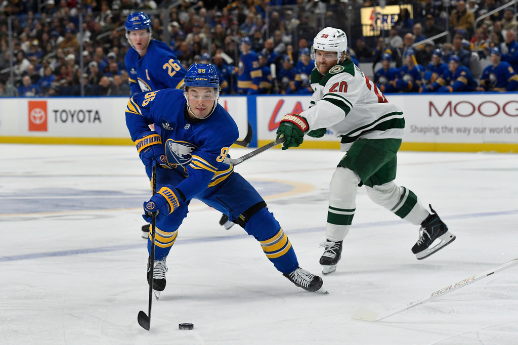 Buffalo Sabres center Noah Ostlund, left, is defended by Minnesota Wild left wing Blake Coleman during the first period of an NHL hockey game Tuesday, Oct. 6, 2026, in Buffalo, N.Y. (AP Photo/Adrian Kraus)