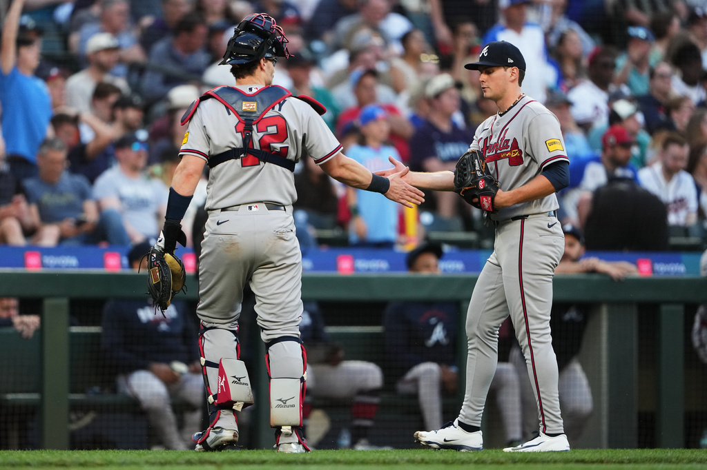 Atlanta Braves catcher Sean Murphy (12) greets starting pitcher JR Ritchie after the fourth inning of a baseball game against the Seattle Mariners, Monday, May 4, 2026, in Seattle. (AP Photo/Lindsey Wasson)