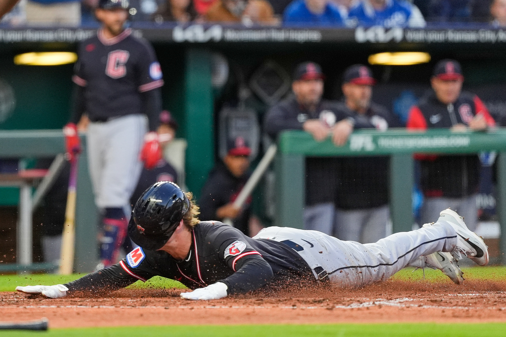 Cleveland Guardians' Petey Halpin slides home to score on a two-run single hit by Chase DeLauter during the fifth inning of a baseball game against the Kansas City Royals, Wednesday, May 6, 2026, in Kansas City, Mo. (AP Photo/Charlie Riedel)