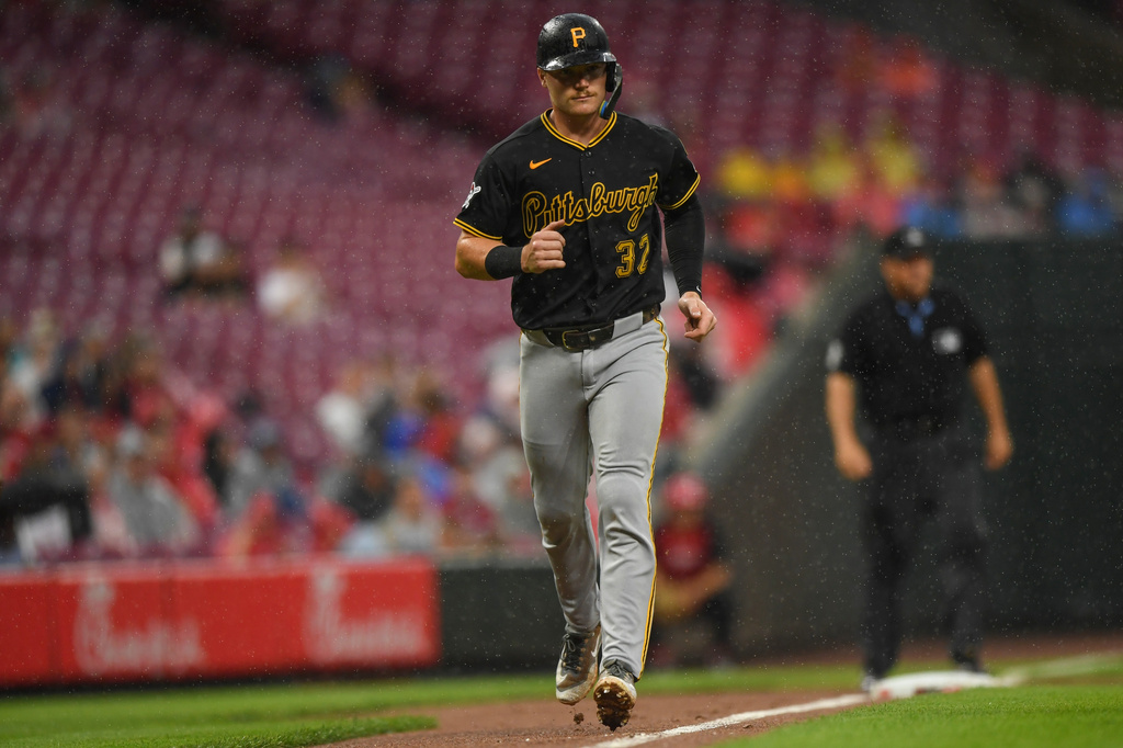 Pittsburgh Pirates' Henry Davis scores after a bases loaded walk is drawn by Bryan Reynolds during the third inning of a baseball game against the Cincinnati Reds in Cincinnati, Saturday, Aug. 1, 2026. (AP Photo/Tanner Pearson)