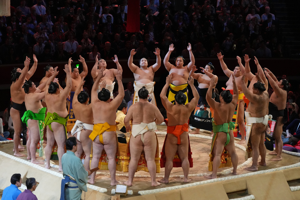 Sumo wrestlers, called rikishi, celebrate the opening on the dohyo, the sacred sumo wrestling ring, during The Grand Sumo Tournament at the Royal Albert Hall in London, Wednesday, Oct. 15, 2025.(AP Photo/Frank Augstein)