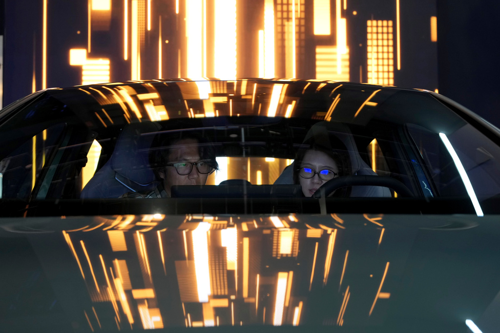 Visitors take a closer look at the latest car during Auto China 2026 in Beijing, Saturday, April 25, 2026. (AP Photo/Ng Han Guan)