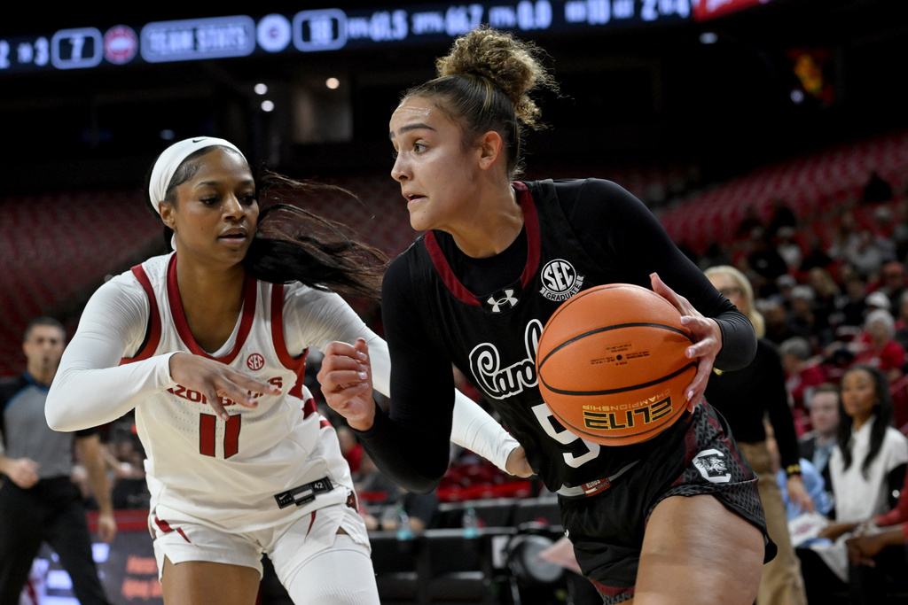 South Carolina guard Tessa Johnson (5) tries to drive past Arkansas guard Wyvette Mayberry (11) during the first half of an NCAA college basketball game Thursday, Jan. 8, 2026, in Fayetteville, Ark. (AP Photo/Michael Woods)