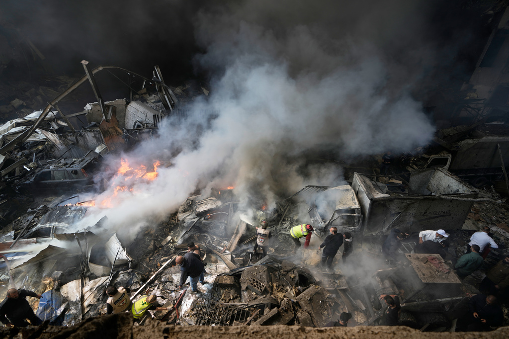 First responders search at the site of an Israeli airstrike that struck an apartment building in Beirut, Lebanon, Wednesday, April 8, 2026. (AP Photo/Bilal Hussein)