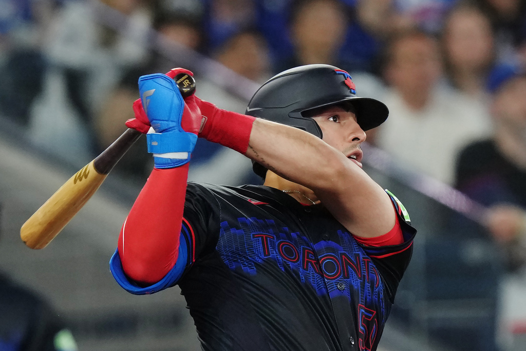 Toronto Blue Jays' Brandon Valenzuela (59) hits a two-run home run against the Minnesota Twins during fourth inning MLB baseball action in Toronto on Friday, April 10, 2026. (Chris Young/The Canadian Press via AP)