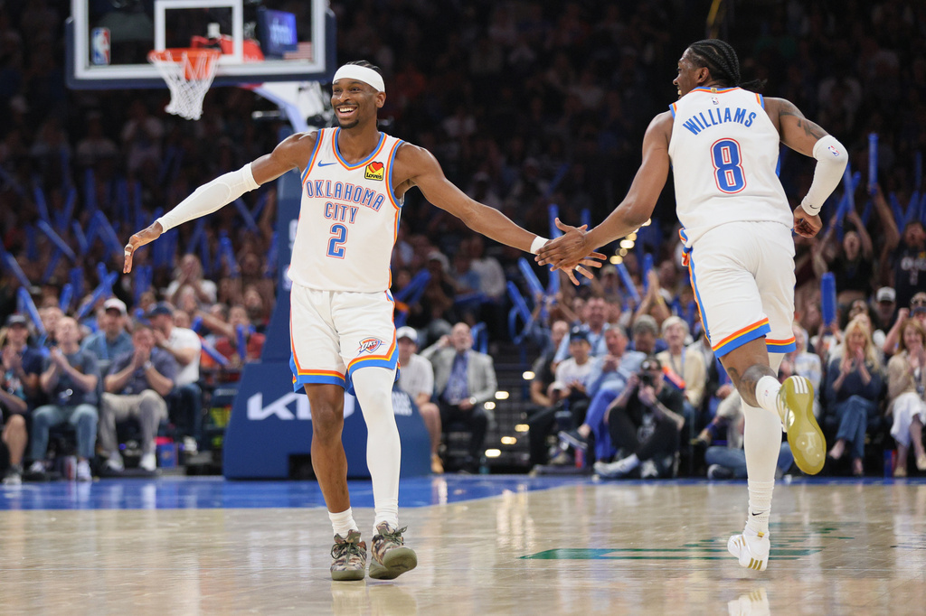 Oklahoma City Thunder guard Shai Gilgeous-Alexander (2) and guard Jalen Williams (8) celebrate after a basket by Williams during the second half of an NBA basketball game Sunday, March 29, 2026, in Oklahoma City. (AP Photo/Nate Billings)