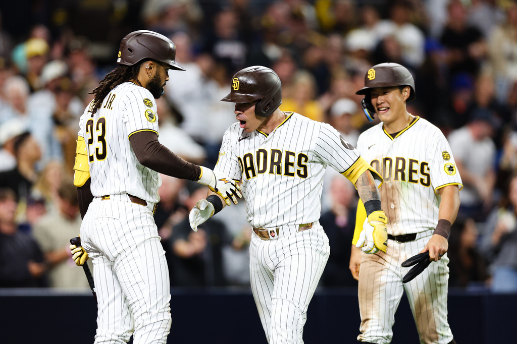 San Diego Padres' Freddy Fermin, center, celebrates with Fernando Tatis Jr. after hitting a two-run home run against the New York Mets in the seventh inning of a baseball game Saturday, June 6, 2026, in San Diego. (AP Photo/Derrick Tuskan)