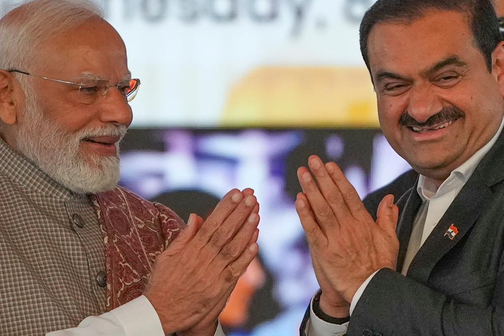 Indian Prime Minister Narendra Modi, left, greets Chairman Adani Group, Gautam Adani during the inauguration ceremony of the Navi Mumbai International Airport in Navi Mumbai, India, Wednesday, Oct. 8, 2025. (AP Photo/Rafiq Maqbool)