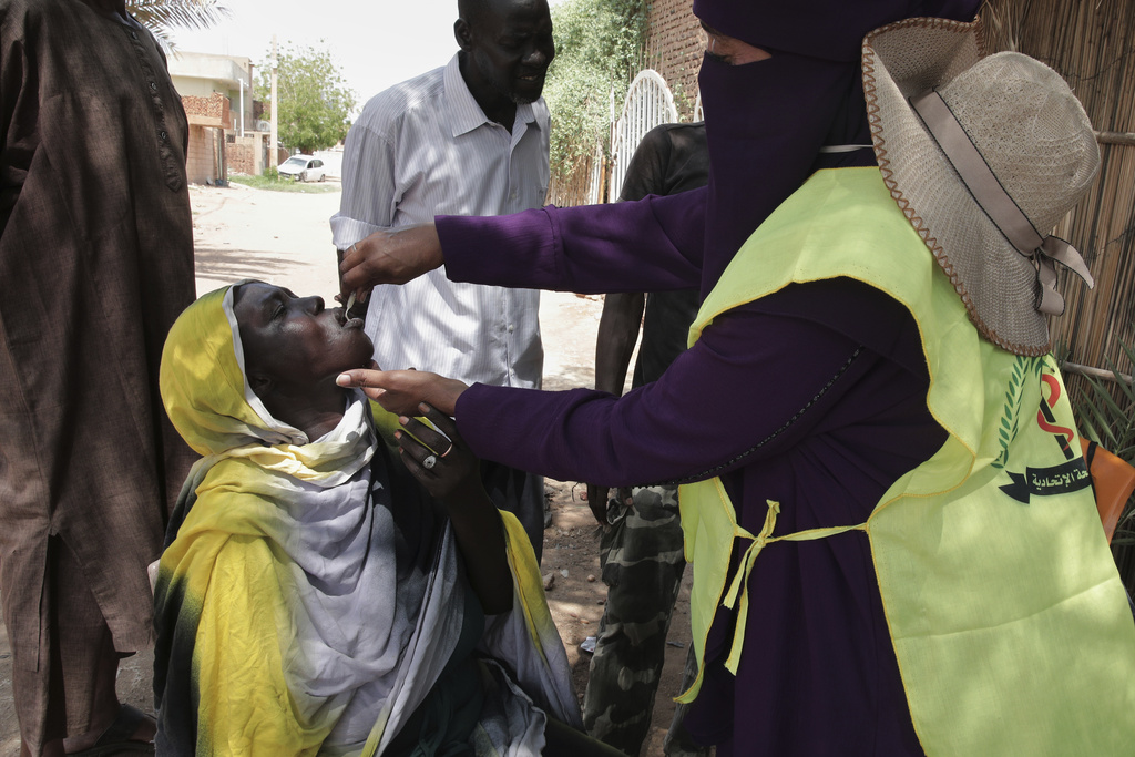 A health worker administers an oral cholera vaccine to a woman during a 10-day vaccination campaign in Khartoum, Sudan, Wednesday, Aug. 13, 2025. (AP Photo/Marwan Ali)