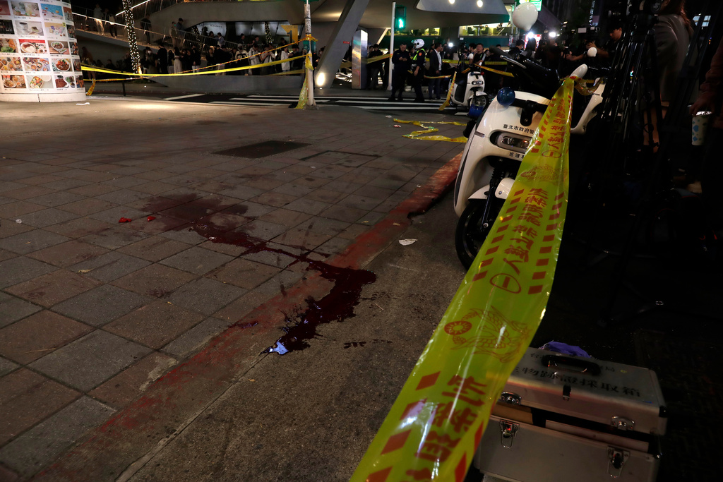 A pool of blood is seen on the ground after the suspect jumped off the building after a knife attack in Taipei, Taiwan, Friday, Dec. 19, 2025. (AP Photo/Chiang Ying-ying)