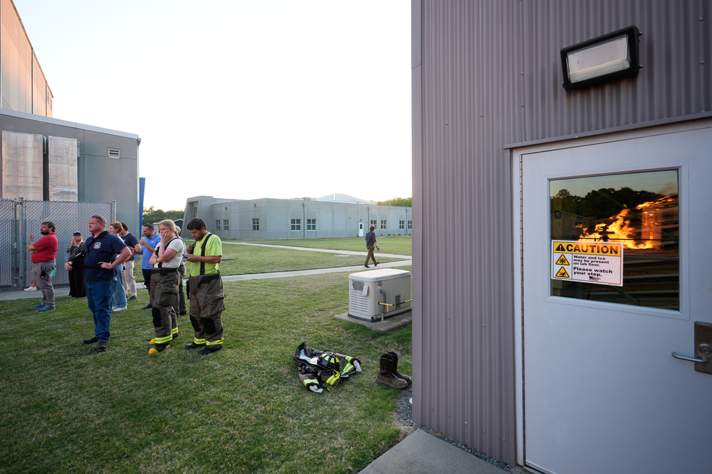 Wildfire researchers and firefighters watch as an accessory dwelling unit burns during an experiment at the Institute for Business & Home Safety center on Thursday, April 16, 2026, in Richburg, S.C. (AP Photo/Erik Verduzco)