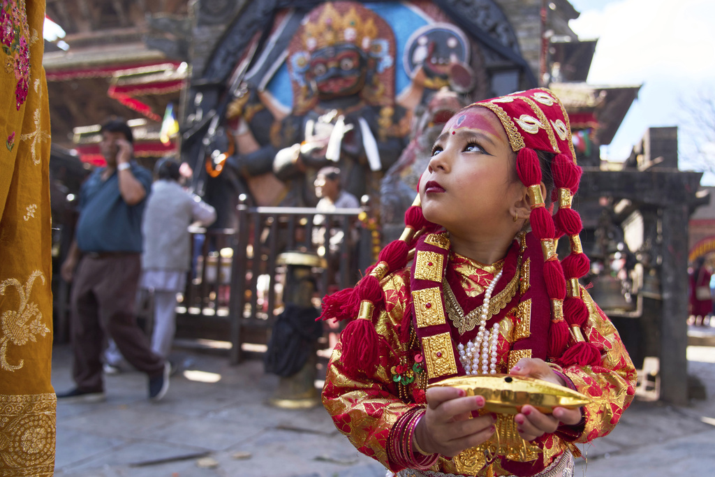 A young Newar girl, dressed to represent divine female energy, waits for Kumari Puja, a ritual during which she would be worshipped, at Hanuman Dhoka, Basantapur Durbar Square, Kathmandu, Nepal, Friday, Sept. 5, 2025. (AP Photo/Niranjan Shrestha)